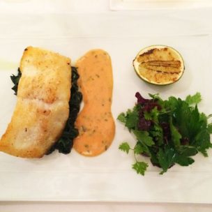 Fillet of turbot served on seaweed, bearnaise sauce, salad, spinach