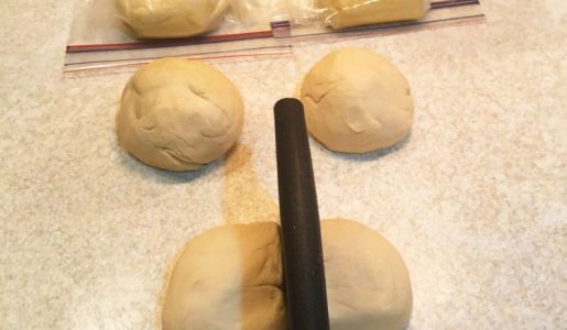 Pizza dough rolled into a ball and can be placed in the freezer